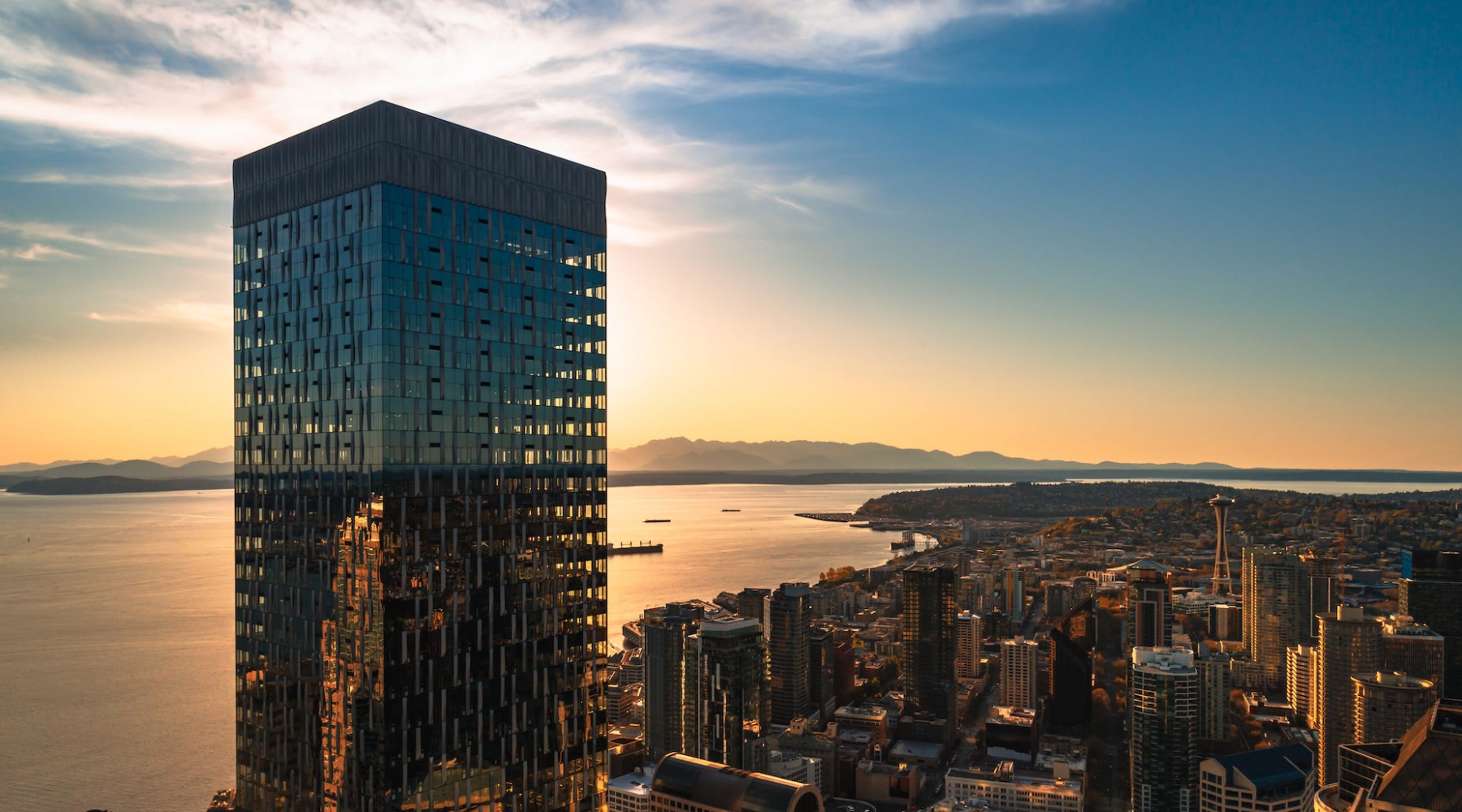 exterior of tower with sunset views of Puget Sound and the Space Needle exterior of tower with sunset views of Puget Sound and the Space Needle