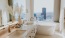 Primary bath with walk in tiled shower, double floating vanity and deep soaking tub.